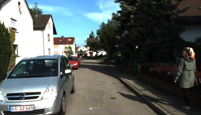 Real RGB target showing a residential street, a car, and a walking person